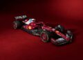 Ferrari unveils its SF-25 F1 car, a striking red Formula 1 racing machine adorned with sponsor logos, perfectly set against a matching crimson background.