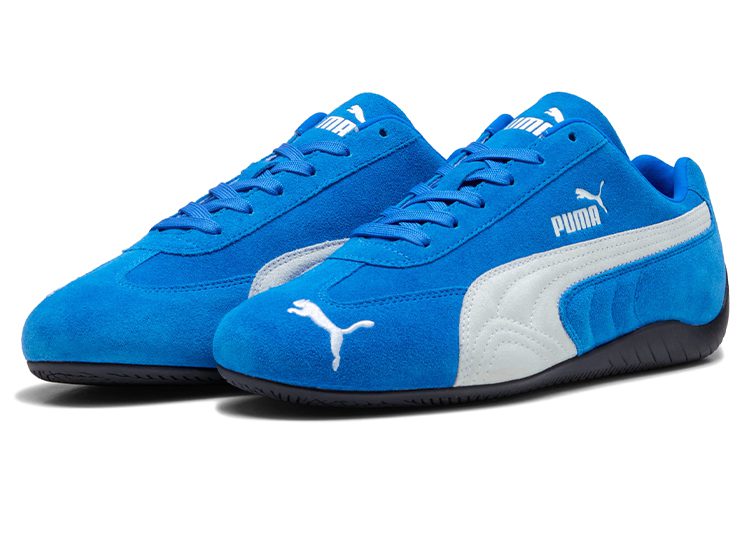 A pair of automotive-inspired blue PUMA sneakers with white accents, featuring the iconic PUMA logo on the side and toe, displayed on a white background. Perfect for any driver seeking both style and comfort.