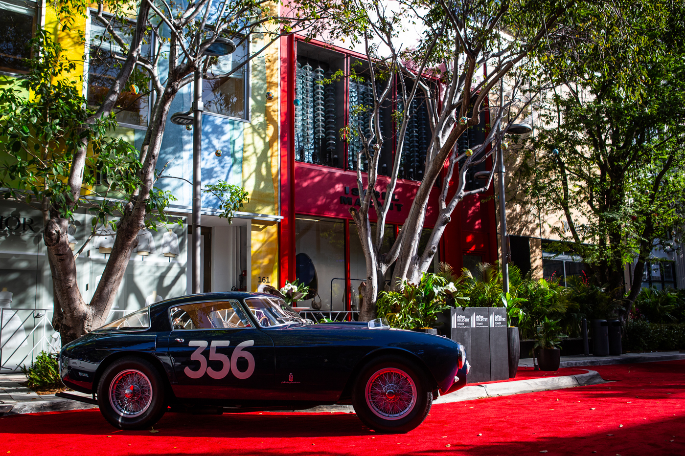 At the 2025 Miami Concours, a classic car bearing the number 356 graced the red carpet, standing proudly among colorful buildings and trees.