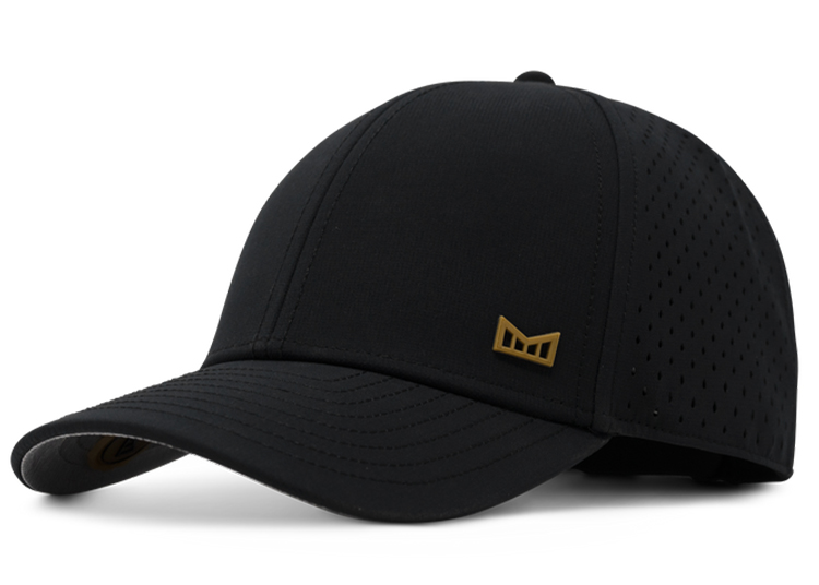 Introducing the Wheels x Wardrobe Black Out baseball cap, adorned with a gold logo on the side. This sleek cap features ventilation holes and a curved brim, perfect for style and comfort.