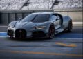 A sleek gray sports car with a streamlined design, bearing the prestigious Équipe Pur Sang emblem, is parked on a race track. The Bugatti flaunts black and red accents, situated near empty spectator stands.