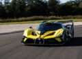 The Bugatti Bolide, a yellow and black sports car, zooms down the racetrack surrounded by trees in its final shakedown test before delivery.