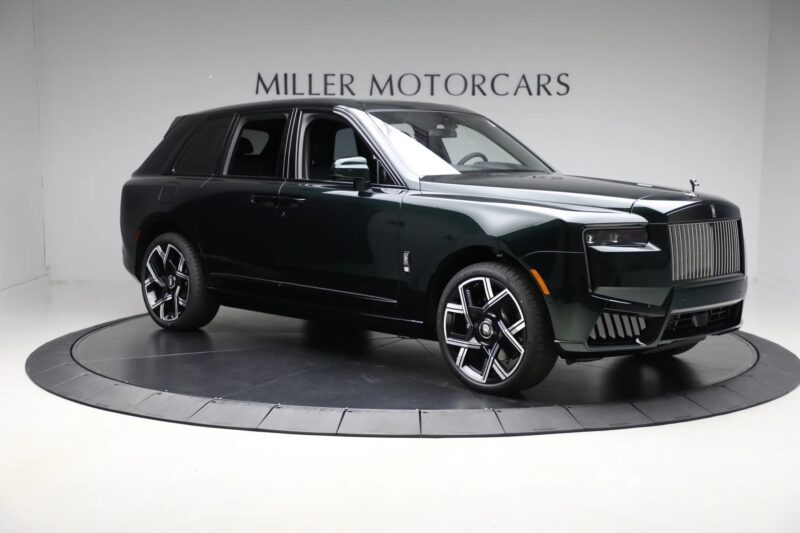 A dark green Rolls-Royce Cullinan luxury SUV is displayed in a showroom with "Miller Motorcars" on the wall behind it, representing the pinnacle of automotive excellence.