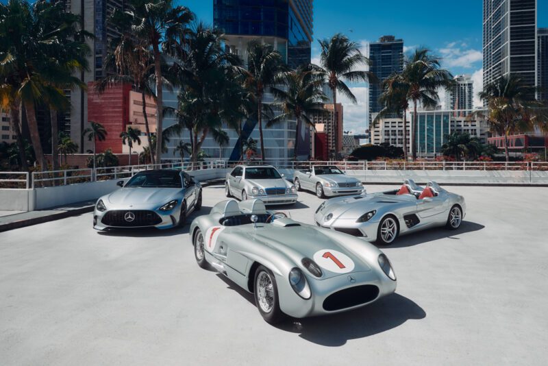 Five Silver Stars shimmer as they line up outside, their sleek Mercedes-Benz designs glinting under the sun. The backdrop of palm trees and towering buildings whispers of a glamorous ModaMiami 2025 scene.