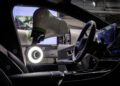 A Mercedes-Benz electric car features a robot arm with a charging plug, seamlessly connecting to the console. Amidst digital displays and control panels, the sophisticated design hints at AI advancements, blurring the line between machines and humanoid robots.