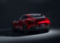 A sleek red Ferrari Purosangue with a modern design is captured from the rear in a dimly lit setting, showcasing its aerodynamic features and dual exhausts. Enhanced by NOVITEC customizations, this masterpiece exudes unparalleled elegance.