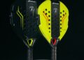 Two sleek padel rackets, one black and one yellow, reminiscent of Lamborghini's elegance, with perforated surfaces and textured grips, stand upright on a circular platform against a black background.