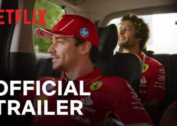 Two individuals in Ferrari caps sit in a car, capturing the thrill of Formula 1. The "Drive to Survive Season 7" on Netflix promises more adrenaline. The words "Official Trailer" overlay the image, hinting at high-speed drama and behind-the-scenes excitement.