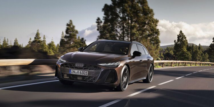 A sleek, dark-colored Audi A6 Avant Wagon glides effortlessly along a forested road under a partly cloudy sky, its hybrid engine whispering with every turn.