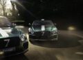 Two green luxury cars from the Le Mans Collection, adorned with white racing stripes, stand poised on the road. Their model names, "Bentayga" and "Continental GT," are clearly visible as sunlight and shadows dance across the scene, capturing the essence of Bentley's elegance.