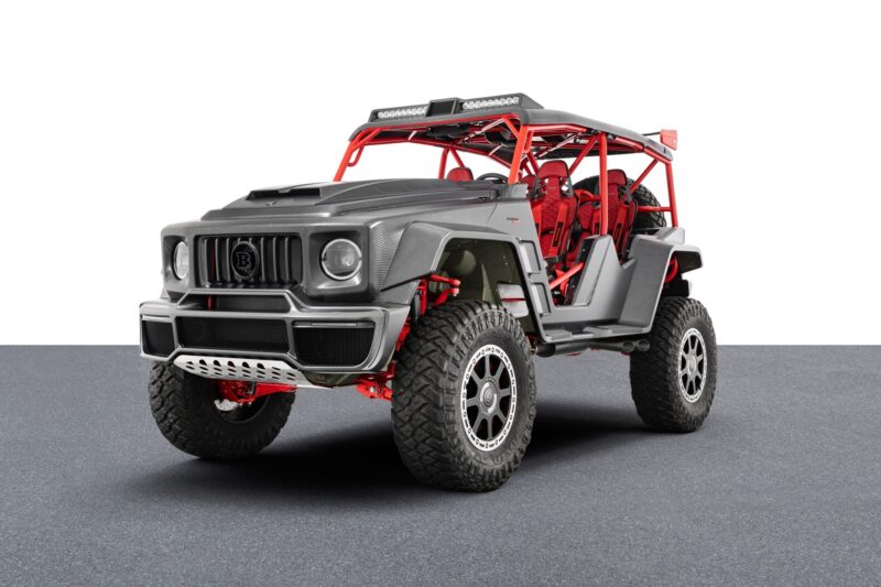 This unique creation is a modified off-road vehicle with a rugged design. Featuring a visible roll cage, oversized tires, and striking red accents, it stands proudly on display in the garage.