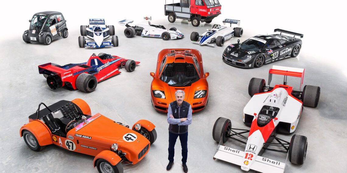 A person stands in front of a diverse lineup of vehicles, featuring race cars, a sports car, a microcar, and a small truck—each a testament to innovative automotive design—all displayed on a pristine white background.