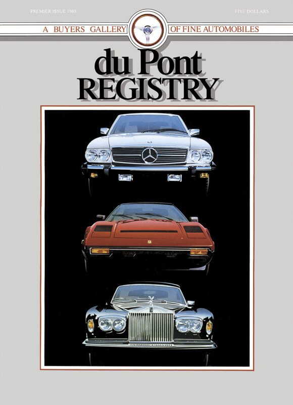 Cover of the duPont REGISTRY Premier Issue 1985 featuring three iconic Cover Cars: a Mercedes-Benz, a Ferrari, and a Rolls-Royce, set against a gray background with a decorative border. Celebrating the 40th Anniversary of luxury automotive excellence.