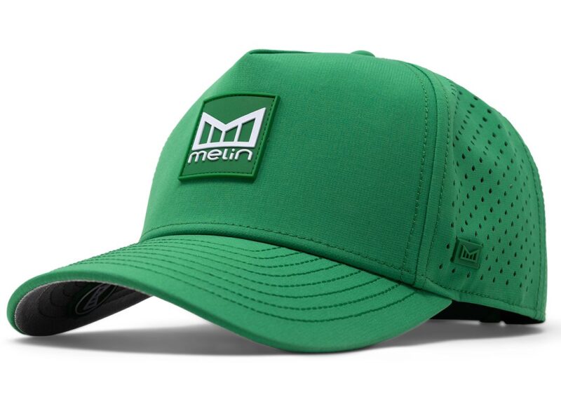 A green baseball cap with a perforated back and a logo patch on the front, perfect for celebrating St. Paddy's Day. The cap features stitching details and a curved brim, ideal for those sunny days.