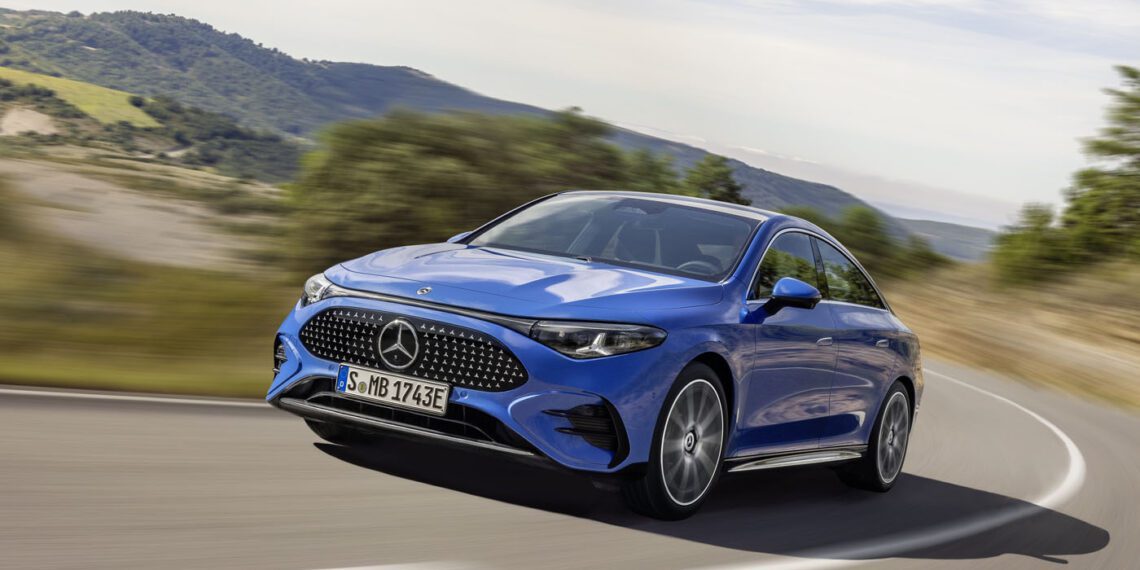 A blue Mercedes-Benz CLA sedan cruising along a rural road, surrounded by lush greenery and rolling hills, showcasing its groundbreaking tech in style.