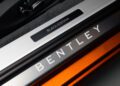 Close-up of a car door sill showcasing the "Bentley" and "Black Edition" text, adorned in an elegant orange and silver design, adding a distinctive touch to the Continental series.
