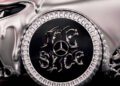A close-up of a customized car wheel featuring a chrome Mercedes-Benz logo and stylized metallic lettering, with a silver, melted-looking car body above it.