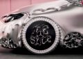 Close-up of a silver luxury car with a melted, dripped effect on the body and custom chrome wheel featuring “MSCHF” lettering and a Mercedes-Benz logo.