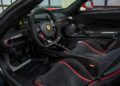 The luxurious interior of the 2017 Ferrari LaFerrari Aperta boasts black and red seats, a steering wheel with the iconic logo, and a sleek dashboard design.