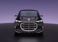 A black Mercedes-Benz concept car viewed from the front, featuring illuminated grille accents and a sleek, modern design reminiscent of a luxury van, set against a gradient purple background.