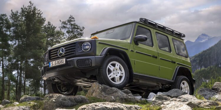 A green Mercedes-Benz G-Class 1-of-460 SUV is parked on rocky terrain outdoors, with trees and mountains in the background under a partly cloudy sky—STRONGER THAN THE 1980s.