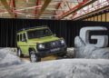 A green Mercedes-Benz G-Class SUV, 1-of-460, is displayed indoors on artificial rocky terrain next to a large metallic "G" sculpture—truly STRONGER THAN THE 1980s.