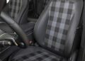 Front view of a Mercedes-Benz G-Class interior shows black leather seats with plaid fabric inserts and white stitching—1-of-460, STRONGER THAN THE 1980s.