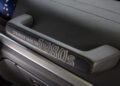 Close-up of a Mercedes-Benz G-Class interior grab handle embossed with "STRONGER THAN THE 1980s," set against a textured dashboard—highlighting its unique 1-of-460 exclusivity.
