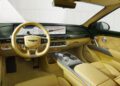 Luxury car interior featuring tan leather seats, a digital dashboard, touchscreen display, and modern controls with metallic accents—showcasing Genesis interior design at its finest.