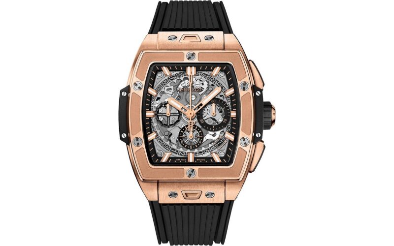 A standout among the best luxury watches, this wristwatch features a rectangular rose gold case, black rubber strap, and a striking skeleton dial that reveals intricate mechanical details and chronograph subdials.