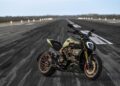 A sleek green motorcycle, reminiscent of Ducati's renowned design, is parked on a runway surrounded by lights. The sky is overcast, casting a dramatic backdrop to the open and expansive environment, evoking the spirit of innovation celebrated at Milan Design Week.