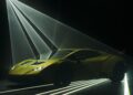 A sleek yellow sports car with aerodynamic design, reminiscent of a Lamborghini, is illuminated by dramatic laser-like beams and set against a dark background.