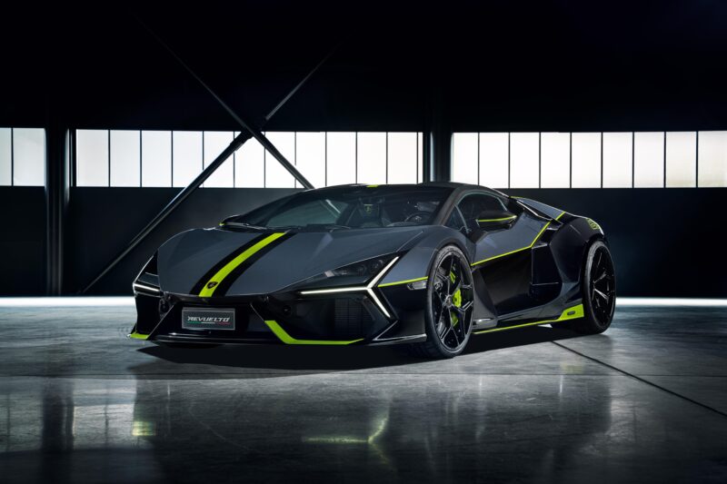 A sleek gray sports car with neon green accents, reminiscent of a Panigale V4 Lamborghini, is parked in a dimly lit garage, showcasing angular design and large rear tires.