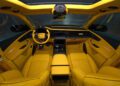 Interior of a luxury Audi RS Q8, featuring bright yellow quilted leather seats, dashboard, and door panels with Mansory customizations, modern controls, and a sleek steering wheel.