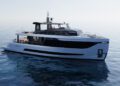 Modern white and black Arcadia Yachts A80new motor yacht floating on calm, clear water under a bright sky, reflecting a commitment to sustainability.