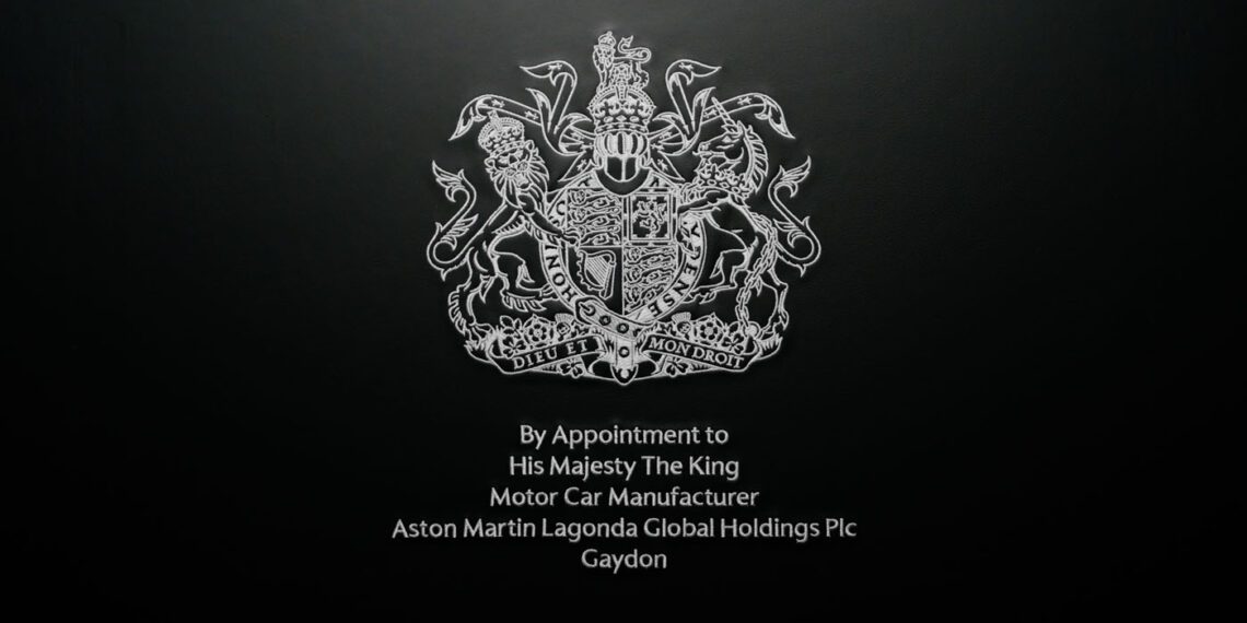 Aston Martin proudly begins using the prestigious Royal Warrant, officially appointed by His Majesty The King as an esteemed motor car manufacturer, symbolized by the iconic royal coat of arms.
