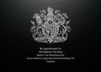 Aston Martin proudly begins using the prestigious Royal Warrant, officially appointed by His Majesty The King as an esteemed motor car manufacturer, symbolized by the iconic royal coat of arms.
