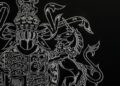 A detailed embroidery of a heraldic emblem on a dark background, featuring a lion and unicorn intertwined with intricate patterns, exuding the elegance of an Aston Martin.