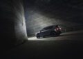 A dark BRABUS SUV is parked in a dimly lit tunnel with rough, textured walls. The vehicle, boasting 637HP, is positioned towards the light at the tunnel's entrance.