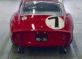 A red Ferrari 330 LM/250 GTO vintage race car with a white circle and the number 7 on the back, parked indoors. The license plate reads "PROVA MO 36." A classic sight ahead of the Cavallino Classic 2025.