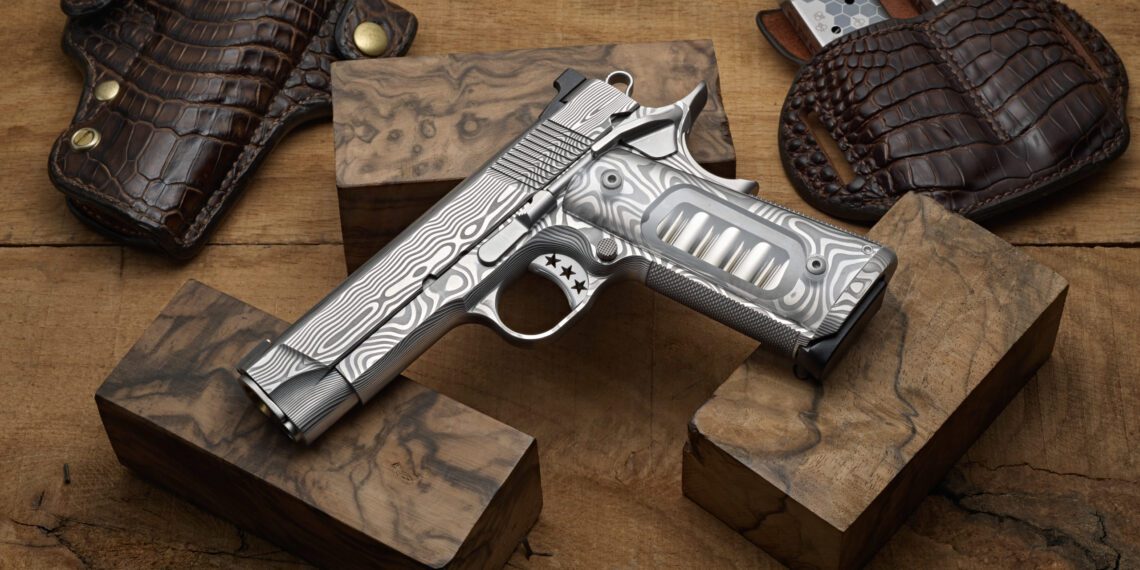 The Ultimate Carry 1911 by Cabot Guns is a masterpiece of American craftsmanship, featuring a silver-patterned pistol with wooden grips elegantly displayed on wooden blocks, surrounded by leather holsters and magazine pouches.