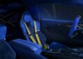 Interior of a Denza Z sportscar featuring blue seats with yellow safety harnesses, a blue dashboard, and a right-side steering wheel—an impressive space for a machine boasting 952 HP.