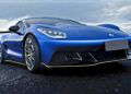 A blue Denza Z sportscar with a low front profile is parked on a paved surface under a cloudy sky.