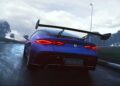 A Denza Z sportscar with a large rear wing and 952 HP powers down a wet race track under cloudy skies, its taillights glowing.