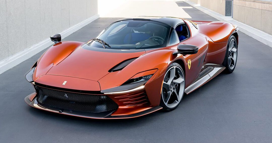 A sleek, orange Ferrari sports car with a modern design is parked on a paved surface, surrounded by the luxury of Beverly Hills' urban architecture and greenery.
