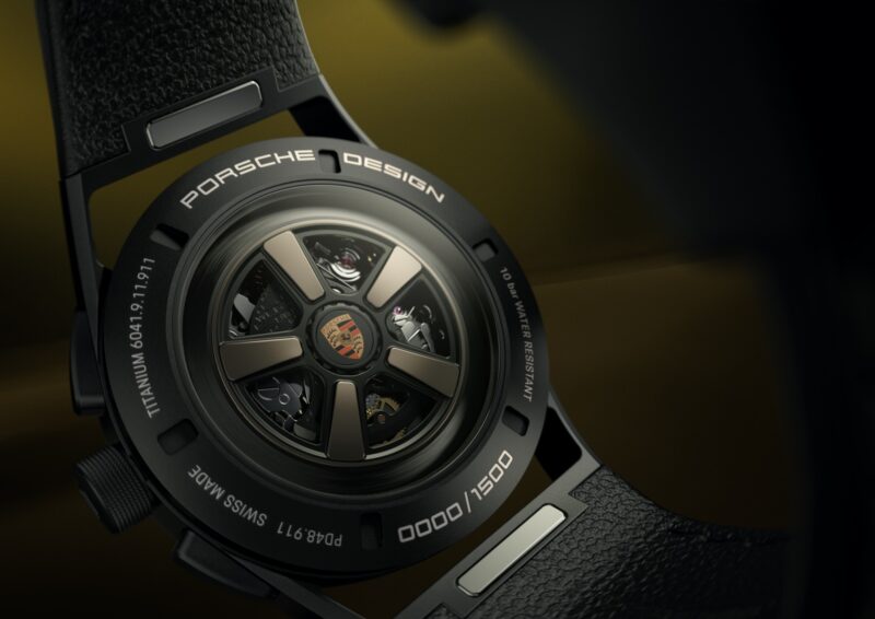 Close-up of the back of a Porsche Design Chronograph 911 watch, showing the exposed movement, titanium details, and owner-exclusive edition number 1000/1500.