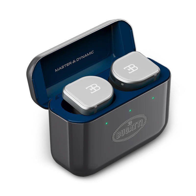 A pair of wireless earbuds with a Bugatti logo in a dark charging case, featuring three green indicator lights and "MASTER & DYNAMIC" text inside the lid—perfect luxury accessories to upgrade your style.