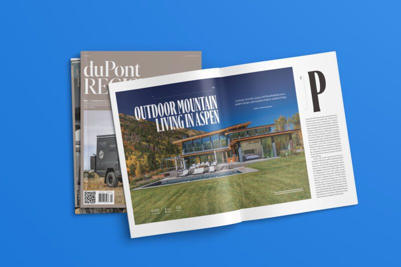 The May 2025 edition of duPont REGISTRY features a stunning double-page spread titled "Outdoor Mountain Living in Aspen," showcasing a modern house. Nestled within No. 480, it sits atop a stack of other enticing magazines.