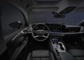 Interior view of a modern Audi A6 sedan featuring a digital dashboard, multifunction steering wheel, touchscreen controls, and black leather seats.