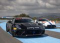 Two Maserati cars thunder down the racetrack in the GT World Challenge Europe; the sleek black one, labeled "Safety Car," and the striking white one, proudly marked "Lead Car," both showcasing "WCUR" banners across their windshields.